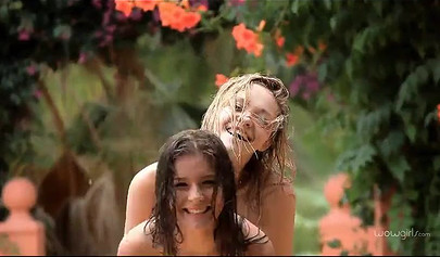 Two skinny teenies with nice titties and fat asses feel each other up in garden