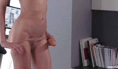 Redhead lesbo is joined by her friend in a strapless dildo fucking session