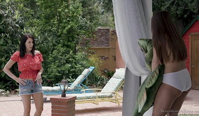 Reagan Foxx and her friend have some fun on the sunbed next to the pool