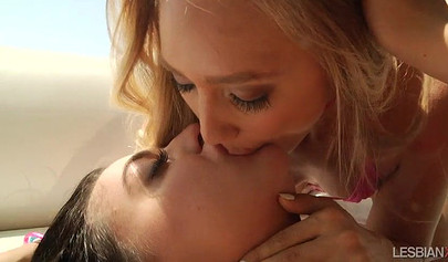 Two lesbians use a large pink dildo to stimulate their assholes and they love it