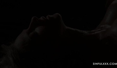 A pair of lesbians have sex in a romantic setting with great lighting and shots