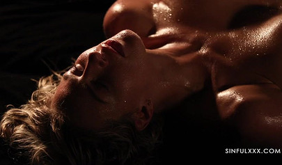 A pair of lesbians have sex in a romantic setting with great lighting and shots