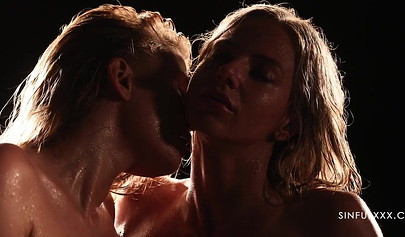 A pair of lesbians have sex in a romantic setting with great lighting and shots