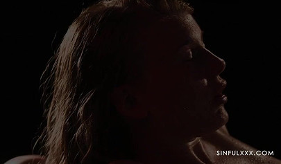 A pair of lesbians have sex in a romantic setting with great lighting and shots