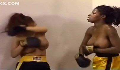 Nymph lesbian interracial Milfs with big tits are having a brutal boxing session
