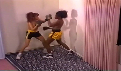 Nymph lesbian interracial Milfs with big tits are having a brutal boxing session
