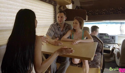 Latina licks a petite lesbian and takes a throbbing cock in her pussy in a van