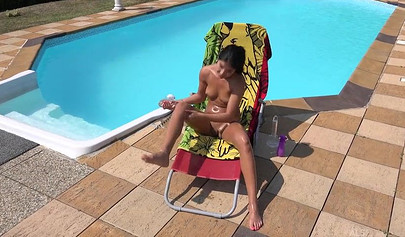 Sexy brunette play with her twat by the pool