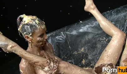 The girls smear each other with spaghetti and have fun