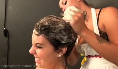 Nice housewife washes her girlfriend's hair and boobs