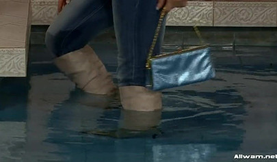 Gorgeous ladies swim in the pool and excite each other