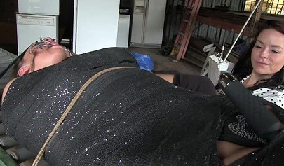 Two experienced MILFs practice bondage in the garage