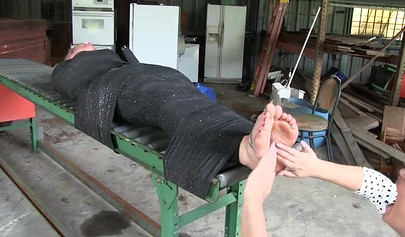 Two experienced MILFs practice bondage in the garage