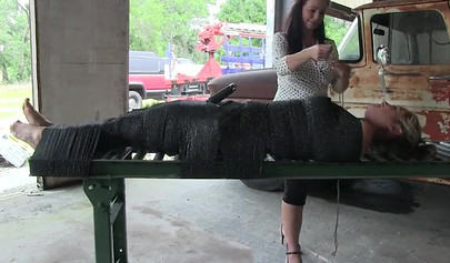 Two experienced MILFs practice bondage in the garage