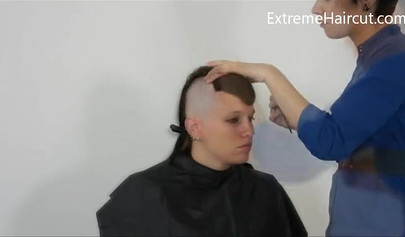 Cute hairdresser makes a punk hairstyle for her girlfriend