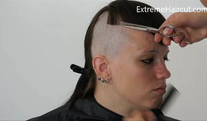 Cute hairdresser makes a punk hairstyle for her girlfriend