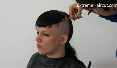 Cute hairdresser makes a punk hairstyle for her girlfriend
