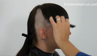 Cute hairdresser makes a punk hairstyle for her girlfriend