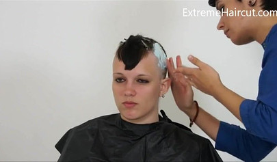 Cute hairdresser makes a punk hairstyle for her girlfriend