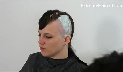 Cute hairdresser makes a punk hairstyle for her girlfriend