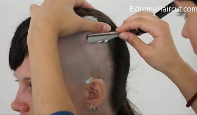 Cute hairdresser makes a punk hairstyle for her girlfriend