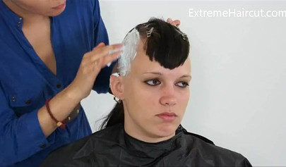 Cute hairdresser makes a punk hairstyle for her girlfriend
