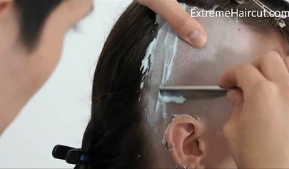 Cute hairdresser makes a punk hairstyle for her girlfriend