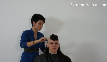 Cute hairdresser makes a punk hairstyle for her girlfriend