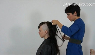 Cute hairdresser makes a punk hairstyle for her girlfriend