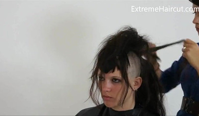 Cute hairdresser makes a punk hairstyle for her girlfriend
