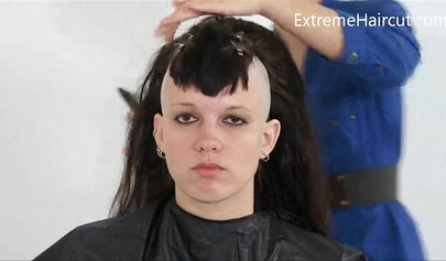 Cute hairdresser makes a punk hairstyle for her girlfriend