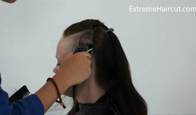 Cute hairdresser makes a punk hairstyle for her girlfriend