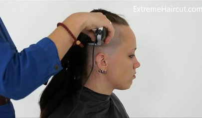 Cute hairdresser makes a punk hairstyle for her girlfriend