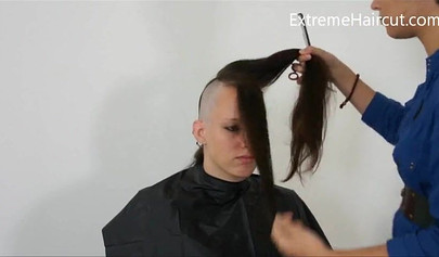 Cute hairdresser makes a punk hairstyle for her girlfriend