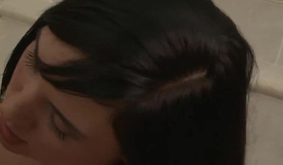 Cute lesbians using a double-sided dildo in the bathroom