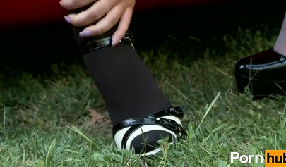 The girls enjoy a foot fetish on the hood of a red car