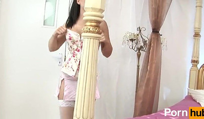 Glamorous brunettes playing with a lilac dildo in the bedroom