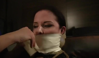 Redhead mistress practices bondage with her submissibve slave