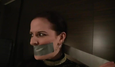 Redhead mistress practices bondage with her submissibve slave