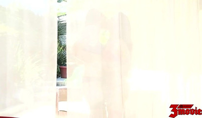 Keira Nicole & Kalina Ryu scissoring on a red round couch