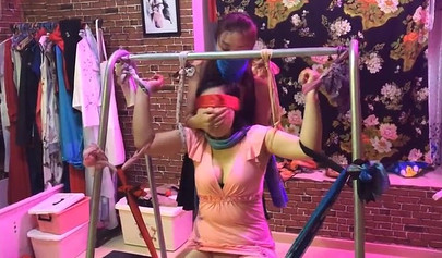 Asian lesbians practice bondage in a BDSM room