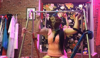 Asian lesbians practice bondage in a BDSM room