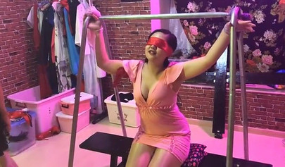 Asian lesbians practice bondage in a BDSM room