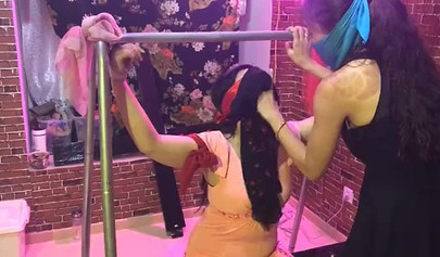 Asian lesbians practice bondage in a BDSM room
