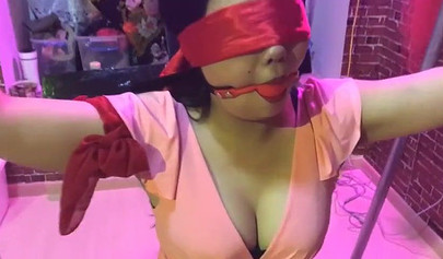 Asian lesbians practice bondage in a BDSM room