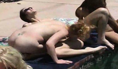 Horny lesbian babes start fooling around by the pool outdoor and end up in an orgy