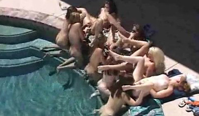 Horny lesbian babes start fooling around by the pool outdoor and end up in an orgy