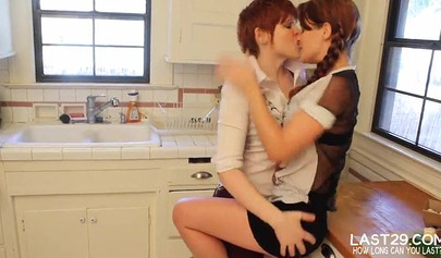 Busty hotties finger each other on a kitchen table