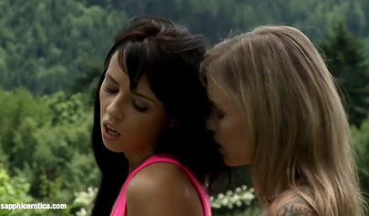 Cute brunette fists her blonde girlfriend outdoors