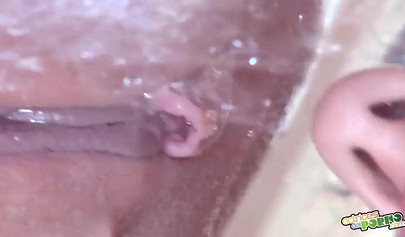 Hot lesbians use a white dildo at the shower